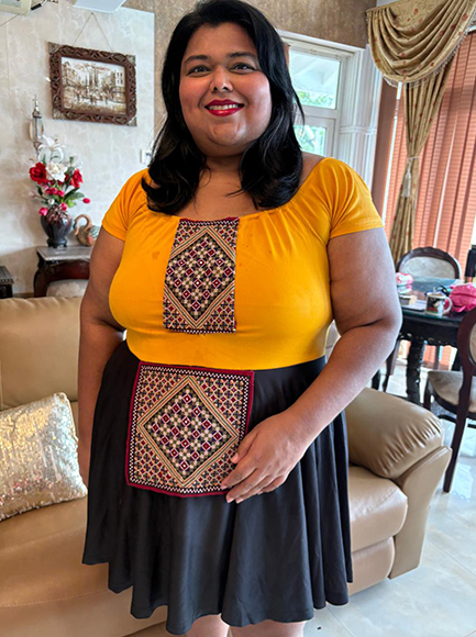 Waiting for guests in a trendy Grasia embroidered dress.